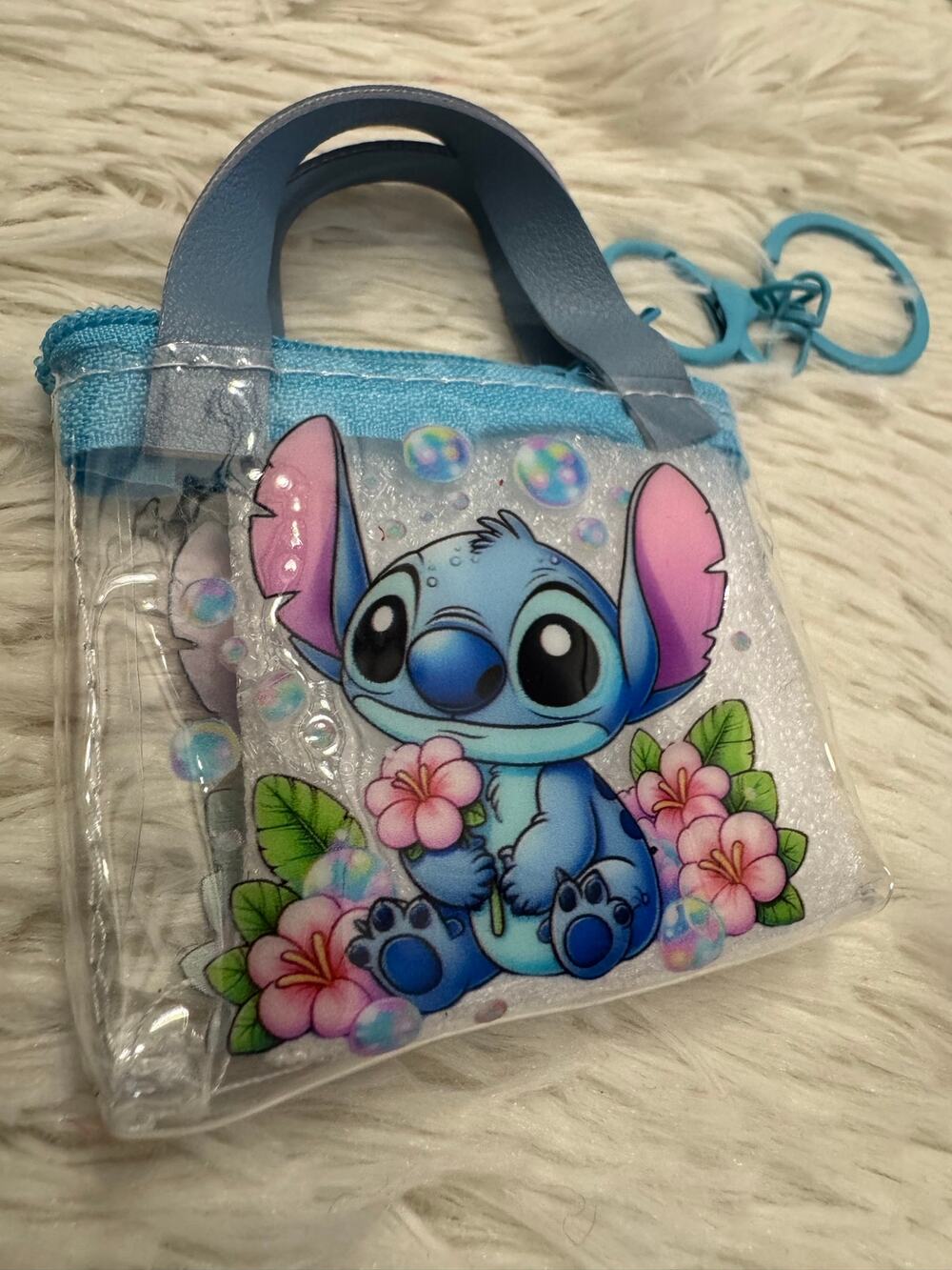 Disney Stitch clear mini purse keychain with blue Stitch holding pink flowers